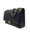 Chanel Black/Gold 
14-
15 Maxi Caviar Double Flap